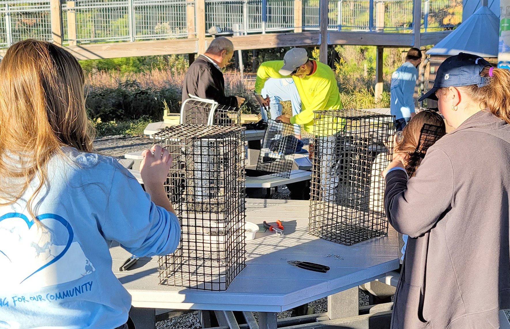 Our team prioritizes caring for our natural resources by participating in activities that focus on protecting waterways and natural resources. Here, our team is building cages to help raise-and-release oysters into the Chesapeake Bay.