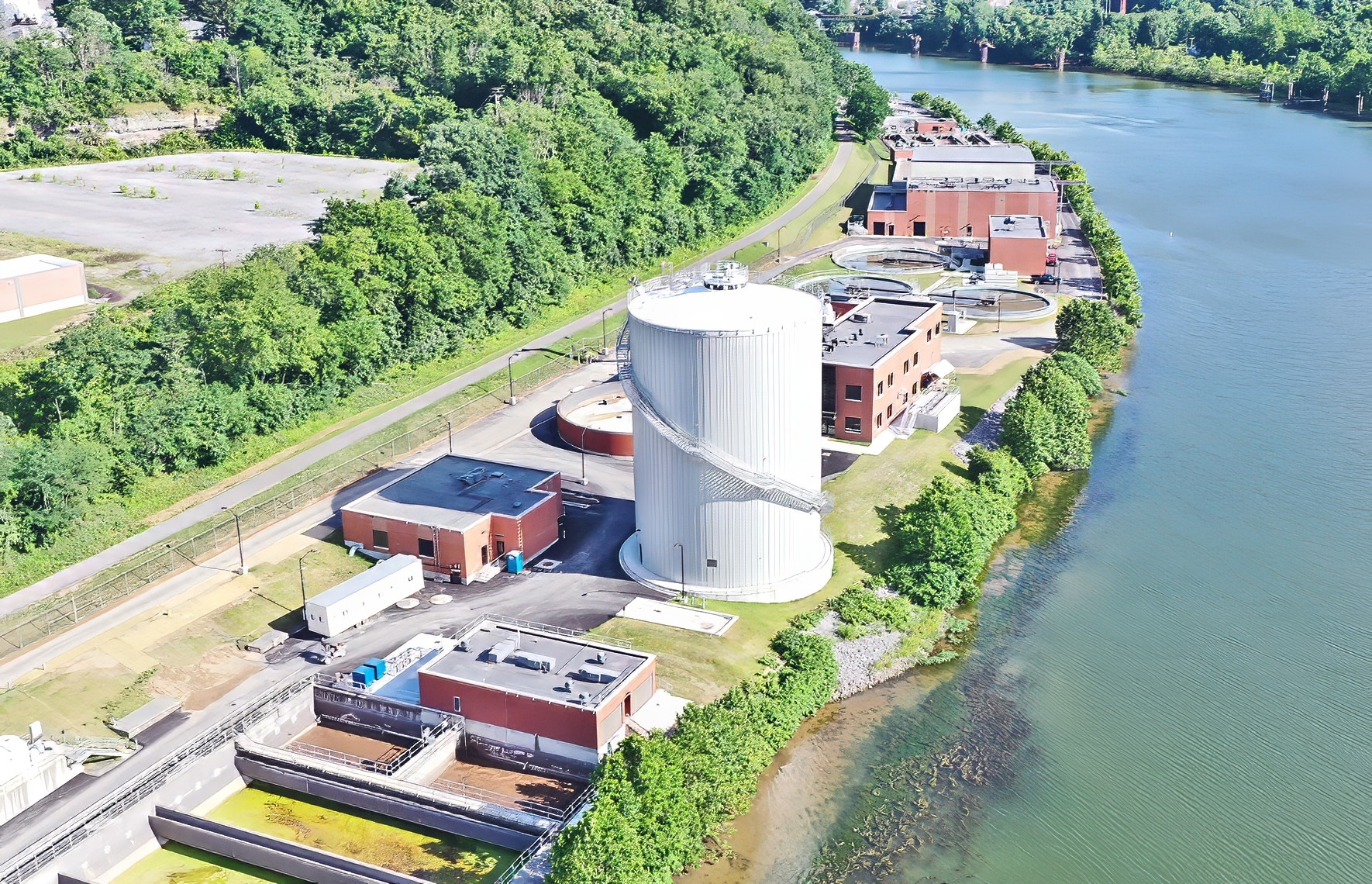 The Star City Wastewater Treatment Plant Improvements project showcases our ability to work in a tight space. The Star City WWTP is constrained to a thin strip of floodplain alongside the Monongahela River, with an active bike path bordering the backside of the plant. These tight quarters required our team to work efficiently as they built a 100'-tall digester and completed other miscellaneous plant improvements.